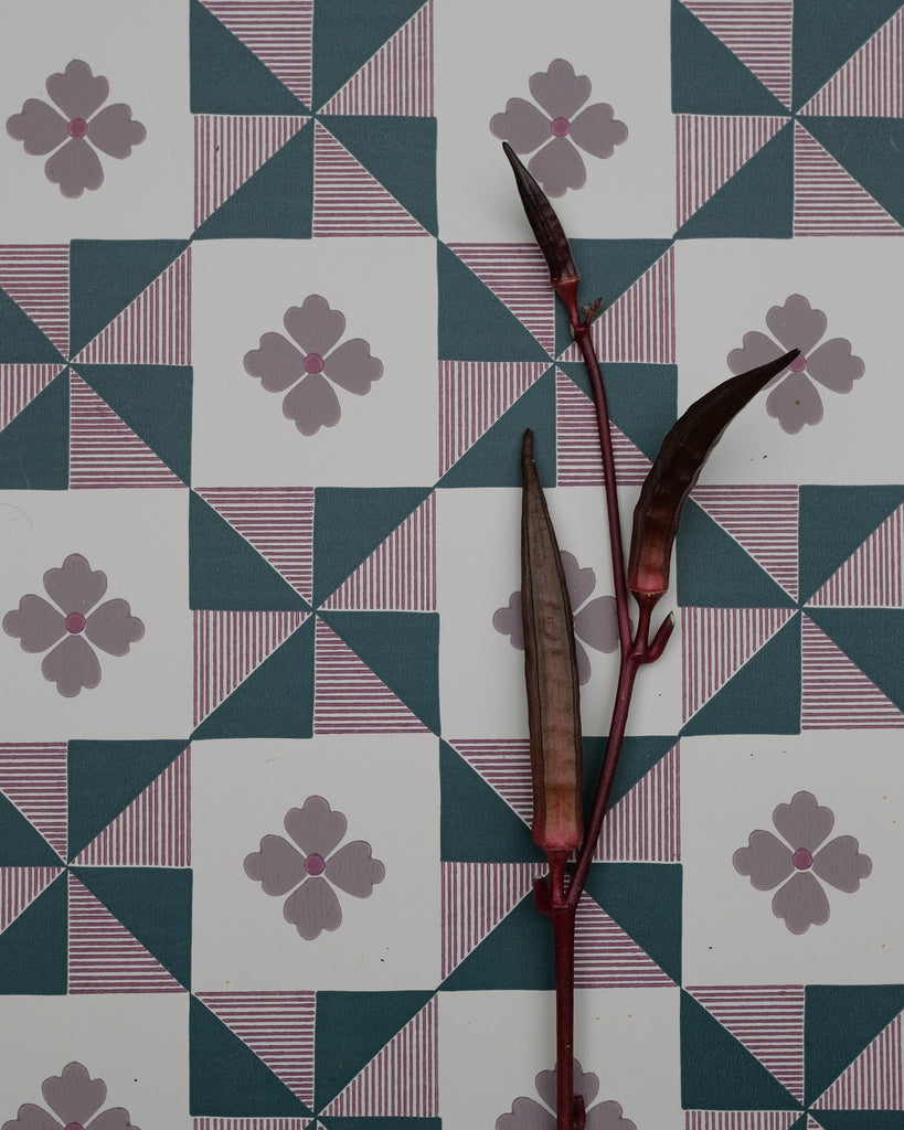 Parita borrows from the bold geometry of vintage quilts, where simple shapes come together to create movement and rhythm. The pinwheel forms are softened by fine hand-drawn stripes and a sweet four-petal flower, bringing a touch of whimsy to the structure. Graphic yet nostalgic, it feels like an old textile reimagined with a playful spirit.