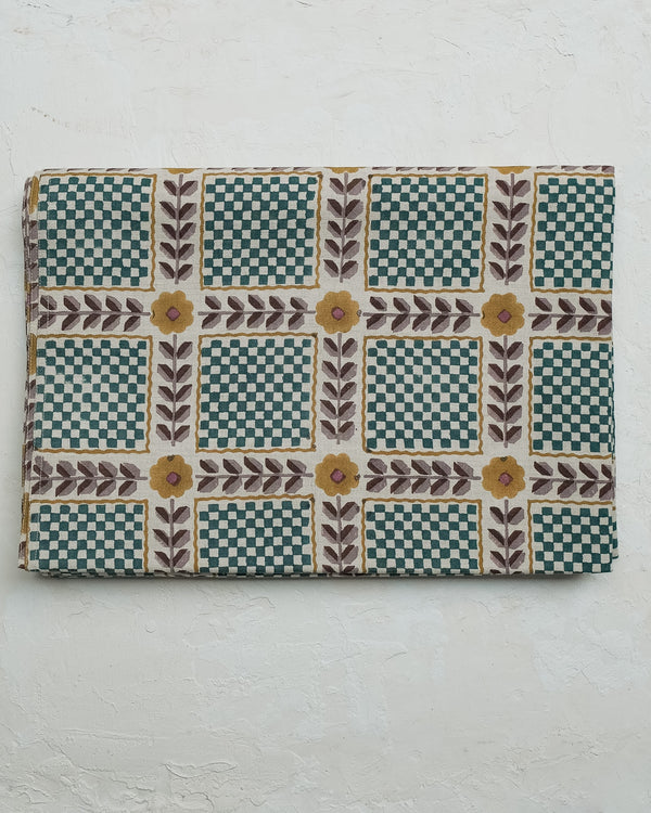 Rectangular fabric sample with a checkered and floral pattern on a white background