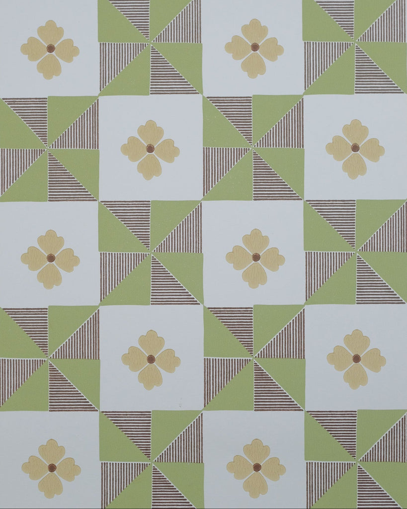 A repeating geometric pattern featuring light green triangles, brown striped triangles, and white squares, each containing a pale yellow four-petal flower motif.