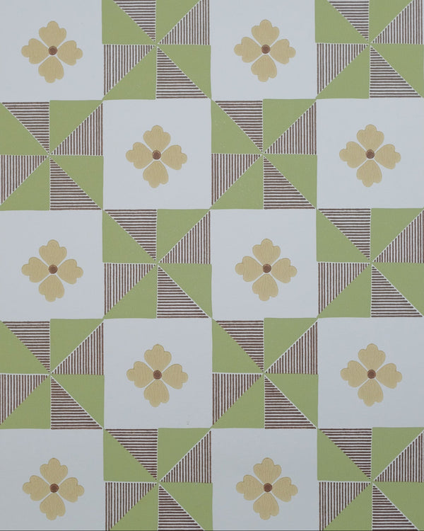 A repeating geometric pattern featuring light green triangles, brown striped triangles, and white squares, each containing a pale yellow four-petal flower motif.