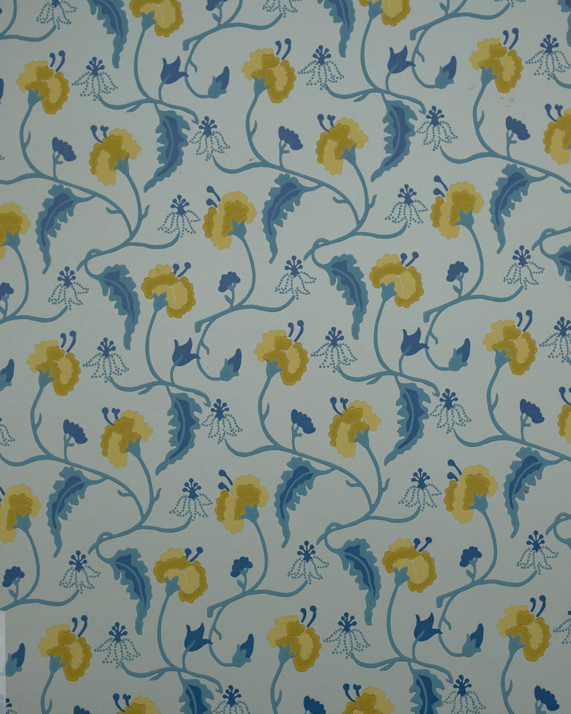 A repeating floral pattern wallpaper or fabric design featuring yellow flowers and blue leaves on a pale blue-gray background.