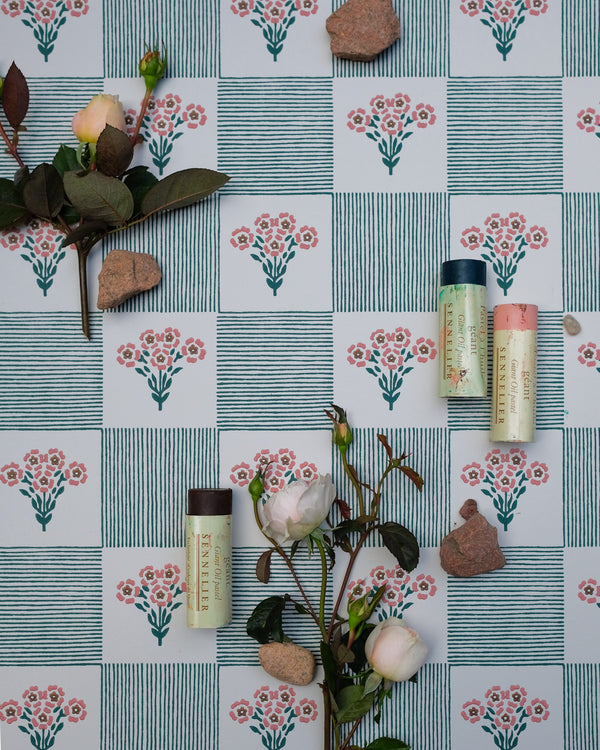 Shabana plays with the nostalgia of old patchwork and hand-stitched quilts, where simple florals and stripes come together in an easy rhythm. Tiny bouquets soften the geometry, while the hand-drawn lines give the pattern a warmth and imperfection that feels collected rather than composed.