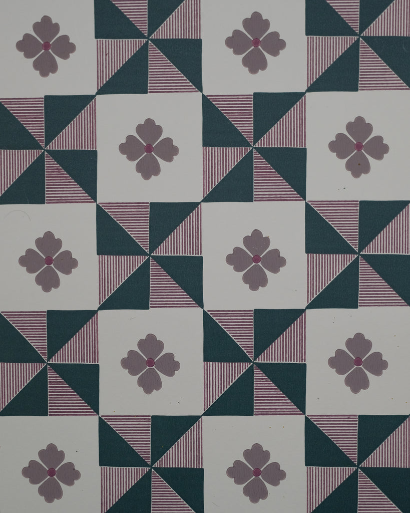 Parita borrows from the bold geometry of vintage quilts, where simple shapes come together to create movement and rhythm. The pinwheel forms are softened by fine hand-drawn stripes and a sweet four-petal flower, bringing a touch of whimsy to the structure. Graphic yet nostalgic, it feels like an old textile reimagined with a playful spirit.