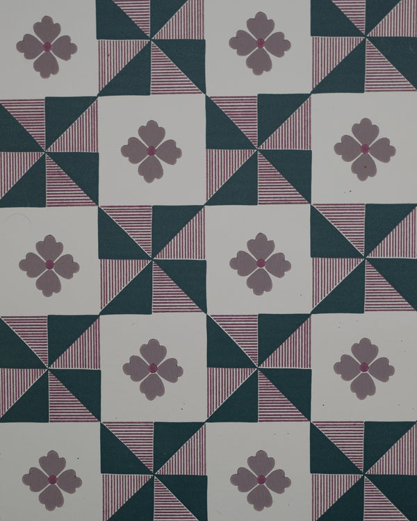 Parita borrows from the bold geometry of vintage quilts, where simple shapes come together to create movement and rhythm. The pinwheel forms are softened by fine hand-drawn stripes and a sweet four-petal flower, bringing a touch of whimsy to the structure. Graphic yet nostalgic, it feels like an old textile reimagined with a playful spirit.